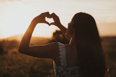 woman forming a heart with your hands